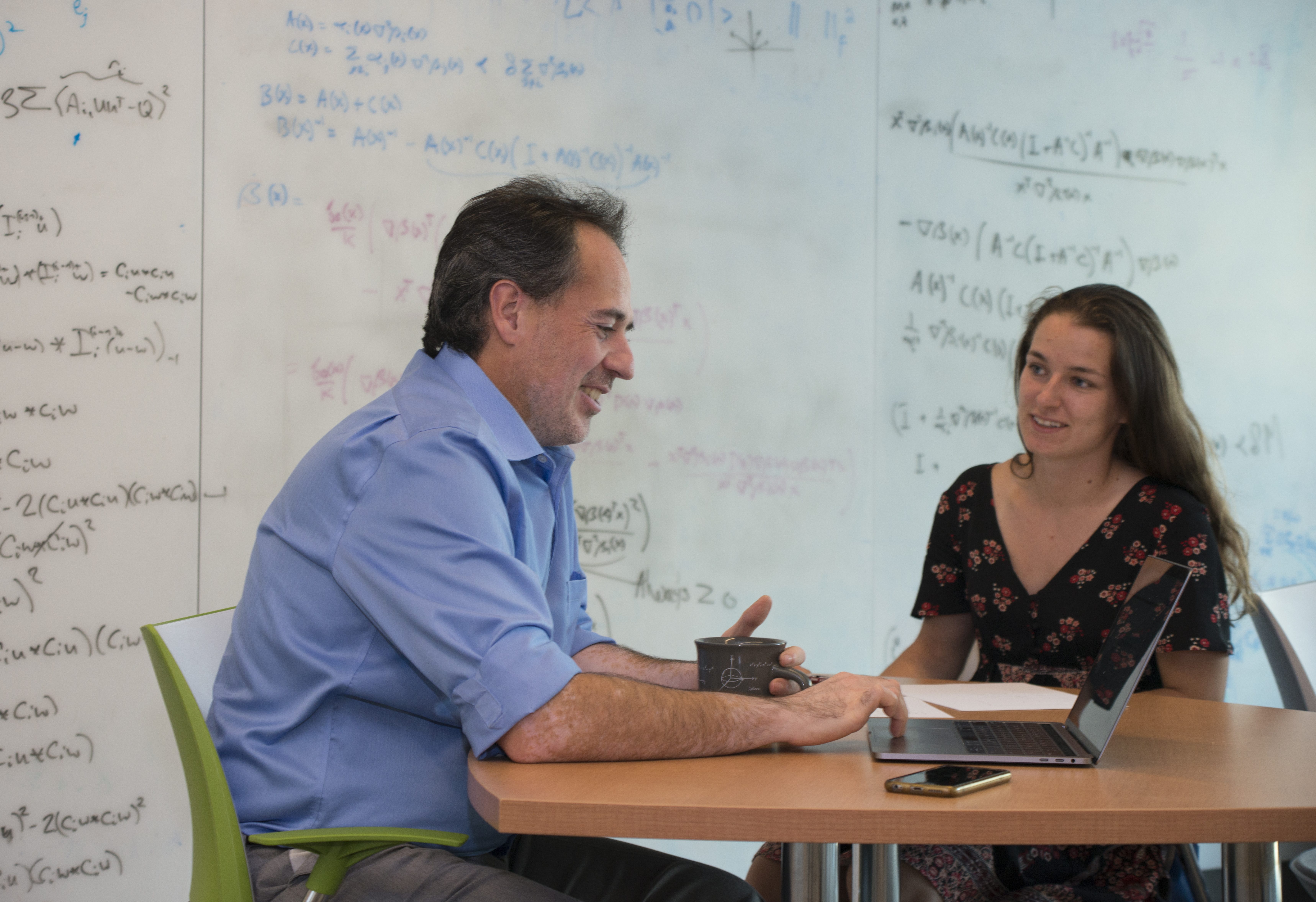 Faculty member and student talking